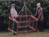 A picture of two men, with an odd-looking wooden frame